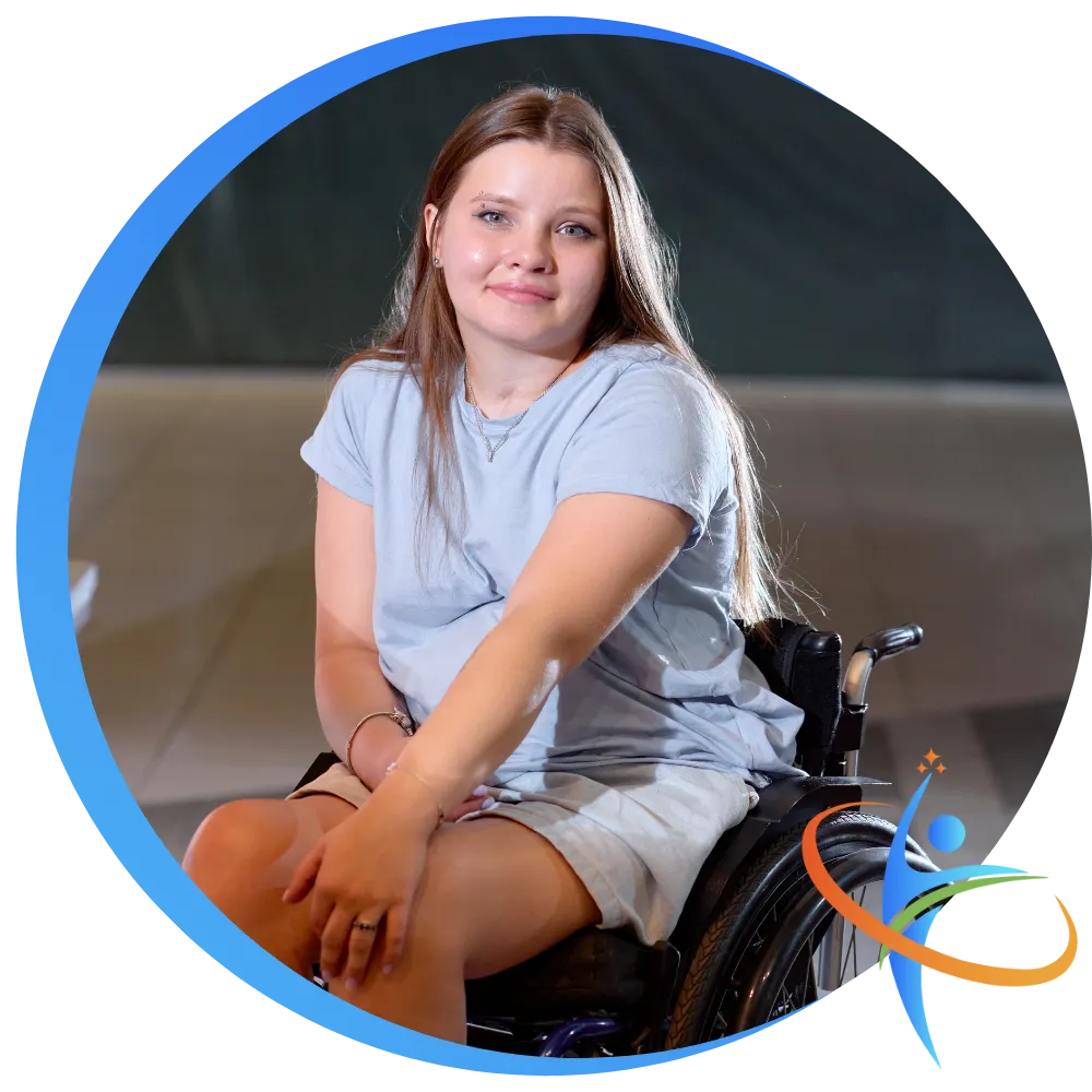 Happy disabled girl in wheelchair smiling at camera