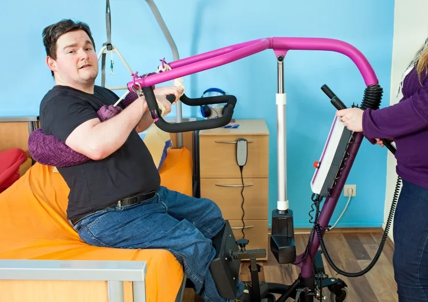 Disabled man using hoist