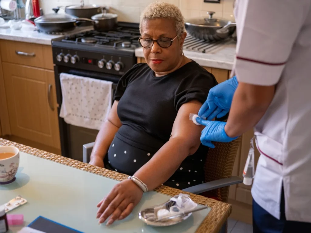 Nurse giving injection to patient at home